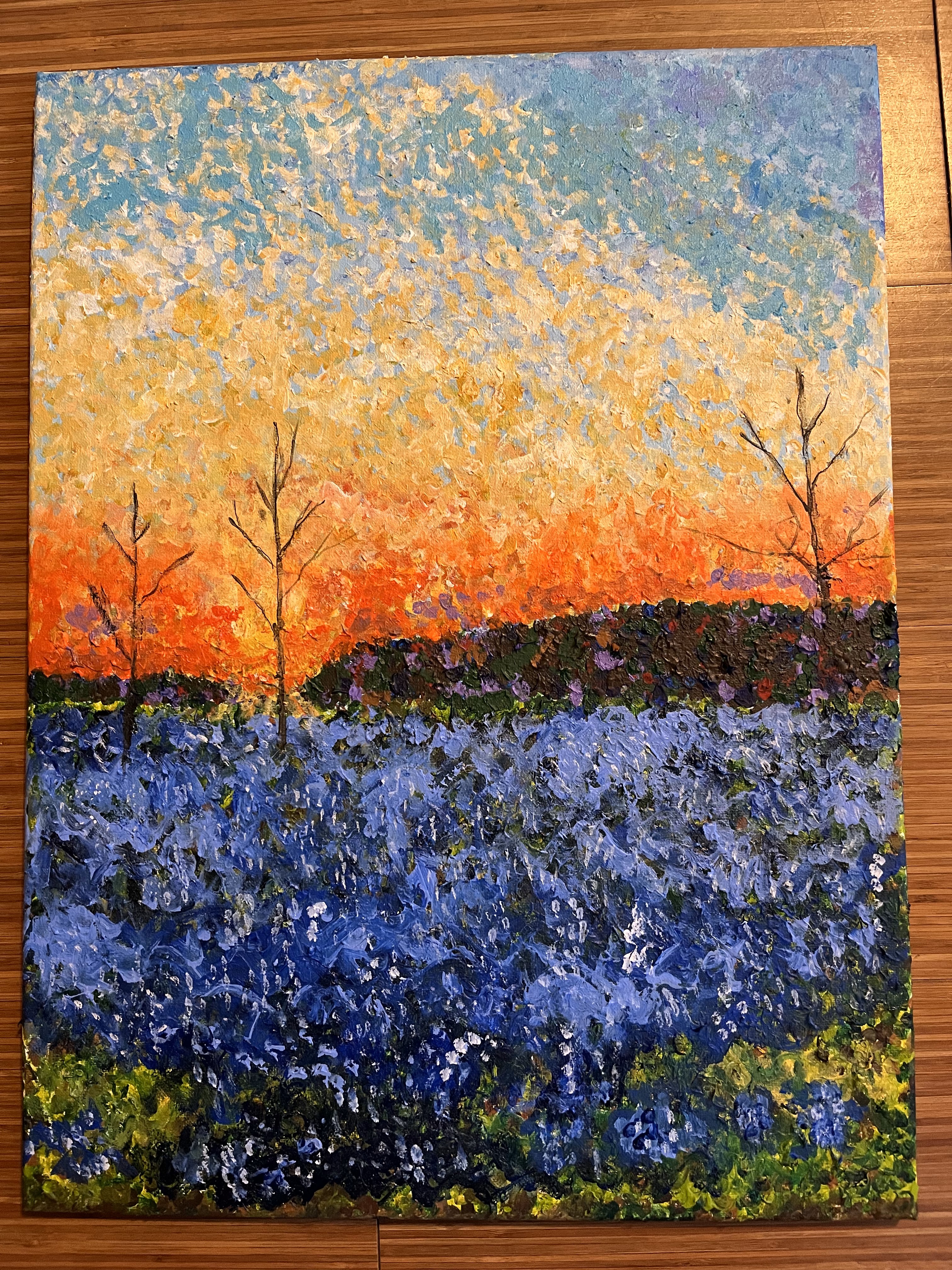 A field of bluebonnets at sunrise